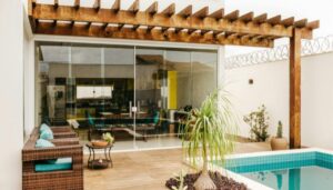 Stylish outdoor living space featuring deck, pool, and efficient patio drainage layout