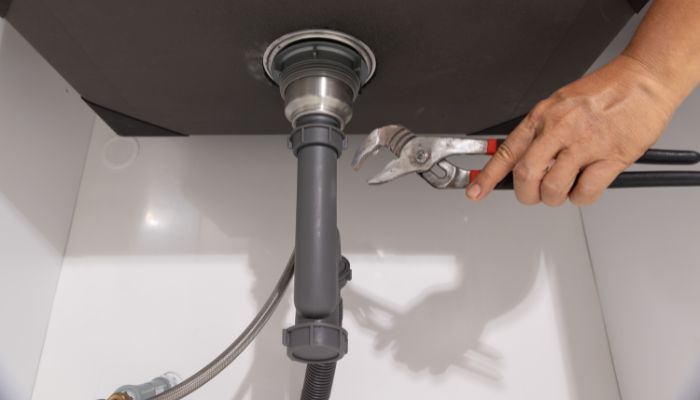 Clogged drain repair under sink by professional plumber in Florida