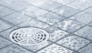 Surface drain managing rainwater runoff to prevent yard flooding and support French drain system in Florida